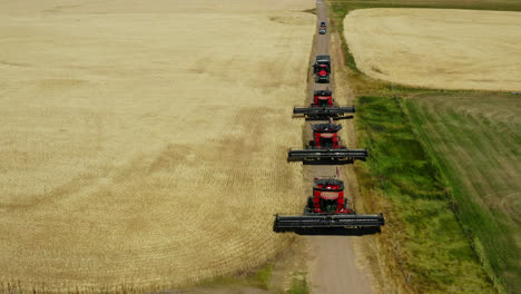 Combine-Harvesters-Driving-In-The-Dirt-Road-To-Harvest-Crops-In-The-Field