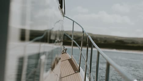 Deck-and-railing-of-boat-rocking-in-sea,-slow-motion