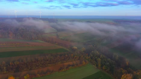 Autumn-Season-In-Rural-Landscape-With-Wind-Turbines-During-Foggy-Day