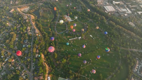 Top-down-aerial-view-of-hot-air-balloons-rising-to-the-heavens