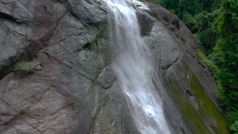 Closeup-of-beautiful-waterfall-in-Langkawi,-Malaysia,-tilt-down-shot