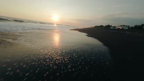 Drone-Flyover-Black-Sand-Shoreline-During-Sunset-At-Playa-de-Monterrico-In-Guatemala