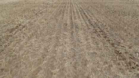 Flying-On-Vast-Farmland-With-Seeding-Tractor-In-Saskatchewan,-Canada