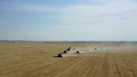 Dust-From-Agricultural-Tractors-Harvesting-Ripe-Crops-At-The-Farm-In-Saskatchewan,-Canada