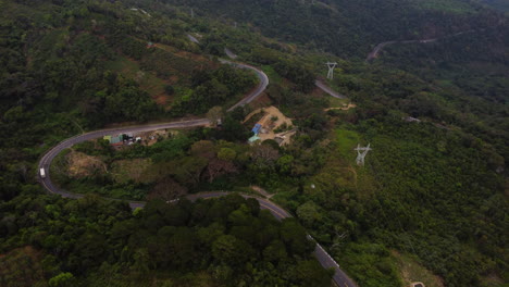 Aerial-over-road-leading-to-Da-lat-in-Vietnamese-countryside-with-truck-delivery