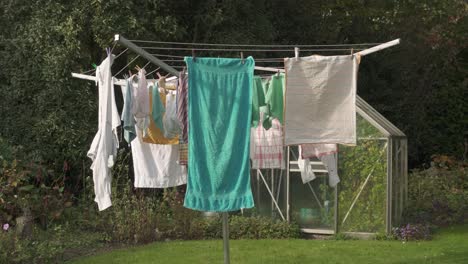 Clothes-Hanging-On-Umbrella-Clothesline-Drying-Rack-Outside-The-House