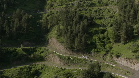 Traveling-Car-In-A-Mountainside-Road-On-The-Southern-Caucasus-Mountains-Near-Vardzia,-Samtskhe-Javakheti,-Georgia