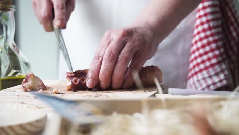 Close-up-shot-of-a-person-hands-cutting-and-preparing-the-octopus