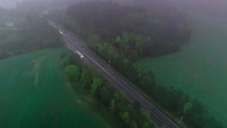 Traffic-on-a-straight-road,-passing-cars-and-trucks-from-an-aerial-view
