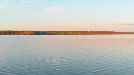 Fixed-Shot-Of-Long-Rocky-Bay-On-Blue-Calm-Water-Lake,-Jugla,-Riga,-Latvia