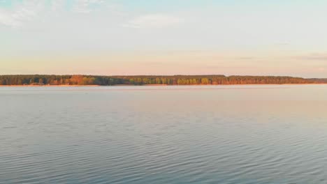 Static-Shot-Of-Rocky-BAy-On-Blue-Calm-Water-Lake,-Jugla,-Riga,-Latvia