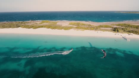 Adrenalin-Kitesurf-on-caribbean-reef-sea,-turquoise-and-white-sand-beach,-Aerial-view-Crasqui-island