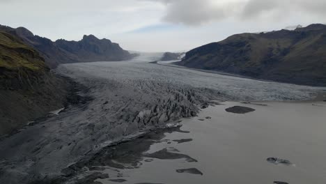 Aerial-view-of-Skaftafell-Glacier-with-Melted-ice-lagoon,-Dolly-sideways-shot,-Iceland