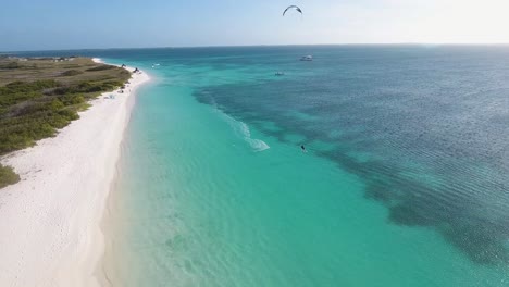 Man-jumps-kitesurfing-and-falls-into-caribbean-sea-water,-drone-shot-Los-Roques