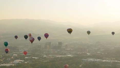 Tight-panning-shot-of-hot-air-balloons-floating-above-Boise,-Idaho