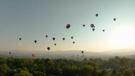 Wide-aerial-view-of-numerous-hot-air-balloons-floating-above-Boise,-Idaho