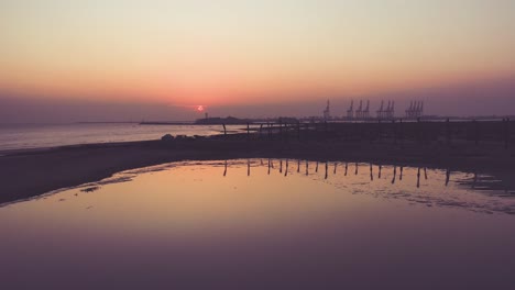 Orange-Sunset-Setting-On-Horizon-With-Karachi-Port-Seen-From-Seaview-Beach