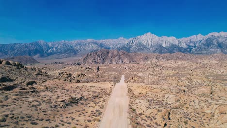 Alabama-Hills-in-Lone-Pine-California-4k-Drone-Footage-Quick-Pull-Back-over-Movie-Road-with-Mount-Whitney-in-the-Background