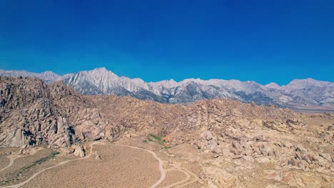 Alabama-Hills-in-Lone-Pine-California-4k-Drone-Footage-Pull-Backwards-over-Offroad-Trails-and-Rock-Features-with-Mount-Whitney-in-the-Background