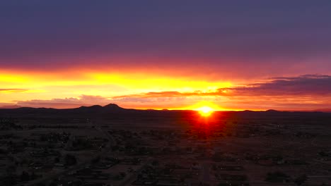 Brilliantly-golden-sunrise-over-California-City-in-the-Mojave-Desert---aerial-time-lapse
