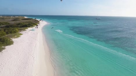 Man-acrobatic-jumps-and-kitesurfing-tricks-caribbean-sea,-drone-shot-Los-Roques