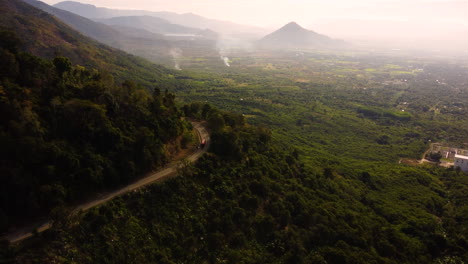Aerial-panorama-of-tropical-landscape-and-curvy-highland-road-to-Da-Lat,-Vietnam