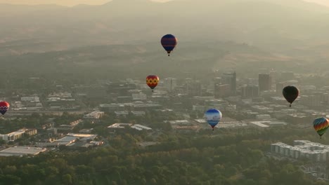 Tight-aerial-view-of-hot-air-balloons-floating-above-a-city