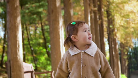 Inspired-Blondie-2-year-old-Child-Girl-Looking-up-in-Autumnal-Park