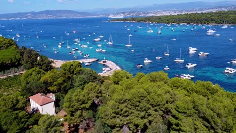 Flying-int-the-direction-of-the-mediterranean-sea,-in-Saint-Honorat-island-part-of-the-Iles-de-Lérins,-next-to-Cannes-in-south-of-France