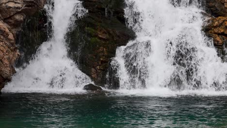 Close-up-of-a-beautiful-waterfall-in-Glacier-National-Park,-Running-Eagle-Falls-named-after-a-female-warrior-Native-American