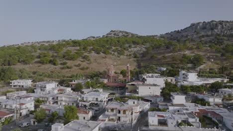 Aerial-over-Pilonas-village-in-Rhodes,-Greece---view-of-Greek-Orthodox-church
