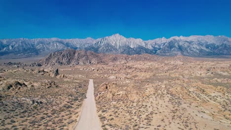 Alabama-Hills-in-Lone-Pine-California-4k-Drone-Footage-Pull-Back-over-Movie-Road-with-Mt-Whitney-in-the-Distance
