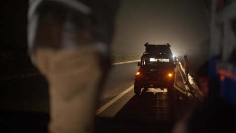 Traffic-Breakdown-at-Night-on-Indian-Motorway,-Help-and-Support,-Car-Puncture-broken-wheel-and-vehicle-on-highway-flashing-hazard-lights