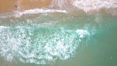 Sunny-Summer-Aerial-in-Israel,-Ashkelon-Beach---Top-down-drone-shot-and-tilt-up-to-the-city