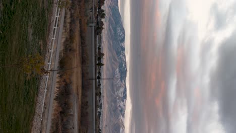 Colorful-mountain-sunrise-cloudscape-with-the-light-on-the-mountain-peak---vertical-orientation-time-lapse