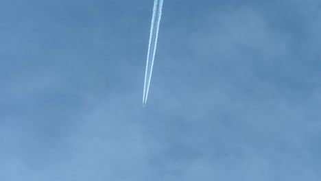 Contrails-in-Blue-Sky-from-Flying-Airplane,-Seen-from-Cockpit-Below