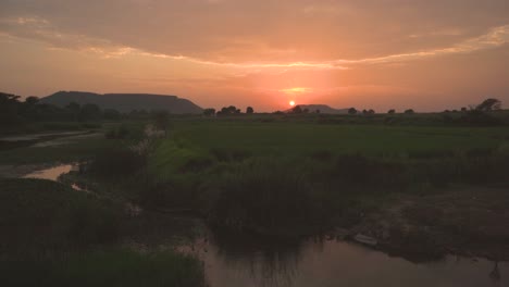 Sunset-in-a-hilly-area-of-Gwalior-with-a-water-stream-and-fin-foreground