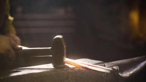 Blacksmith-striking-metal-with-hammer