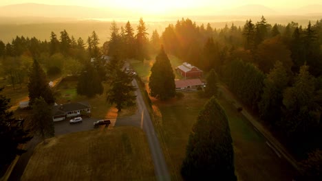 cinematic-sunset-drone-shot-in-forest-with-a-remote-residential-house-with-sun-rays-peaking-beautiful-aerial-4k-filmed-in-Renton-Washington