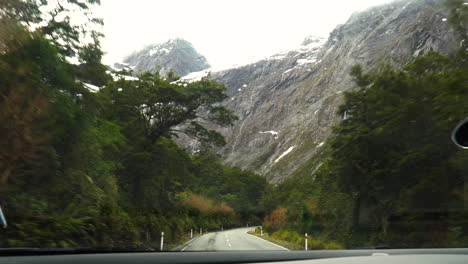 Shot-while-driving-through-a-road-in-Fiordland-National-Park-leading-to-Milford-Sound,-New-Zealand-at-daytime