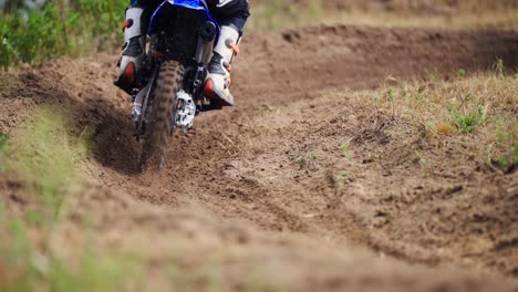 Motocross-Racers-Passing-Curve-Sand-Dirt-Road-in-slow-motion