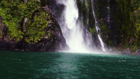 Magnificent-Stirling-falls-in-Milford-Sound-Fjord,-New-Zealand,-from-cruise-boat