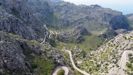 Drone-flying-over-mountain-road-in-Tramuntana,-Mallorca