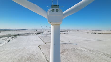 Close-up-of-wind-turbine-with-blades-spinning-in-snowy-landscape-near-Lafayette,-Indiana