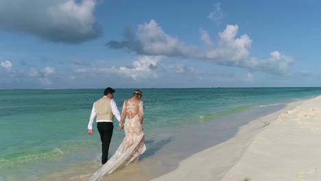 COUPLE-GROWN-AND-BRIDE-WALKING-ON-WHITE-SAND-BEACH-CAYO-DE-AGIA-ISLAND