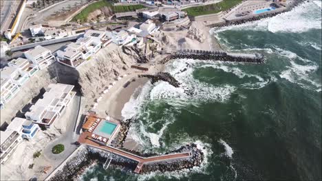 Drone-shot-of-a-private-beach-with-swimming-pool-in-Peru