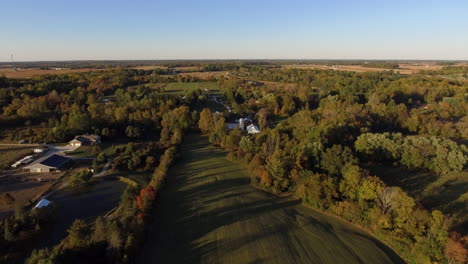 Drone-shot-of-outdoor-wedding-venue-in-a-rural-location-with-fall-colors,-aerial-shot