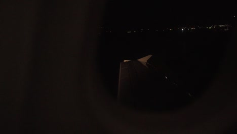 Airplane-wing-seen-from-window-while-landing