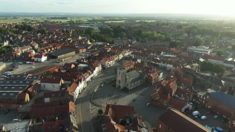 Sunrise-drone-view-over-historic-church-in-English-market-town