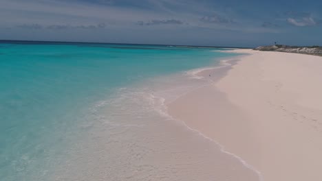 Aerial-footprint-on-white-sand-beach-and-couple-in-romantic-glamping-tent,-paradise-island-Los-Roques